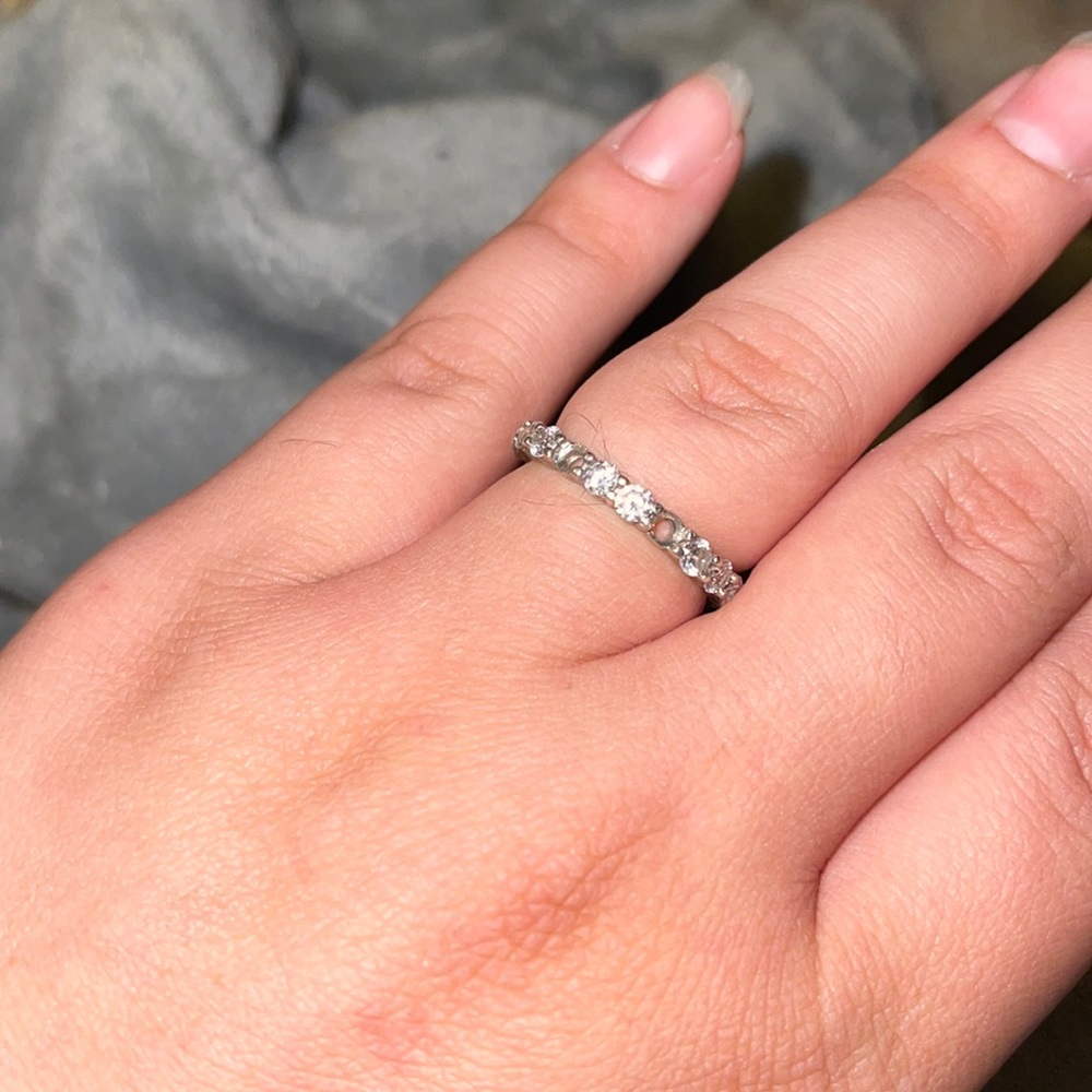 Silver wedding band with 2 diamonds missing